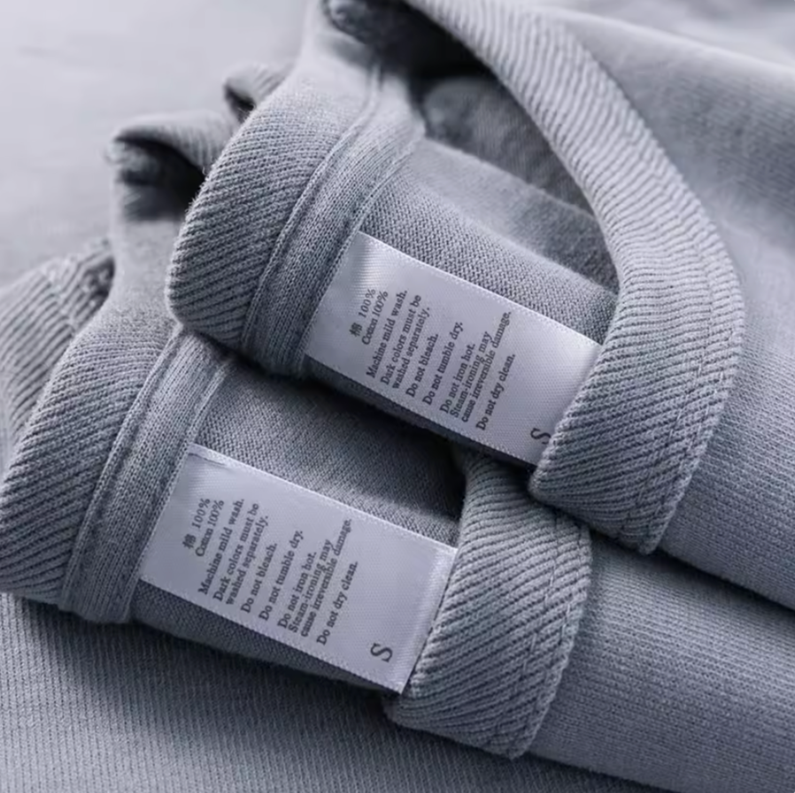 Lavender All-Season Tee Gray Blue cotton T-shirt stacked with care label detail close-up
