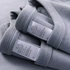 Lavender All-Season Tee Gray Blue cotton T-shirt stacked with care label detail close-up