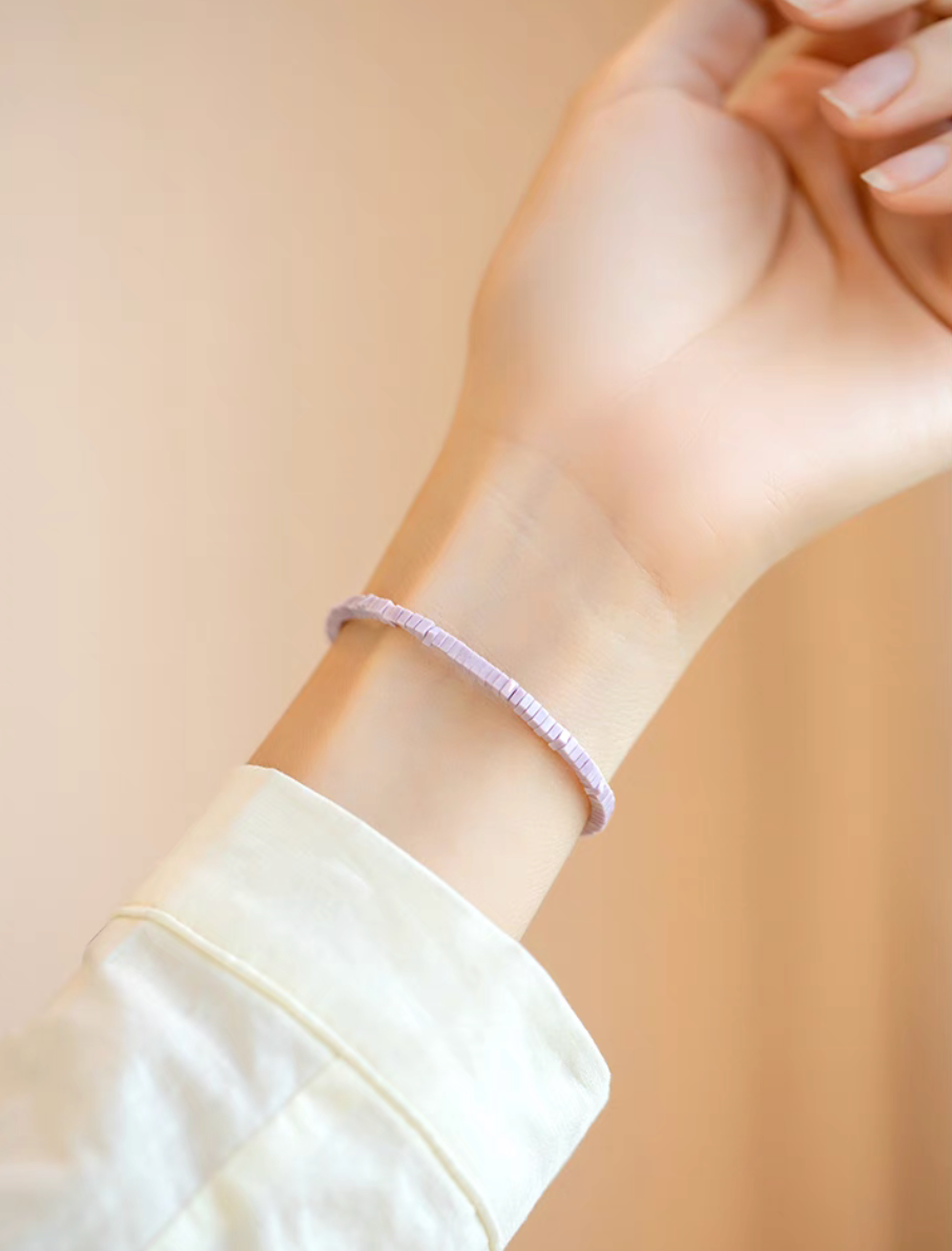 Lavender lepidolite micro tile bracelet worn on wrist in soft natural light highlighting subtle purple tones and minimalist style