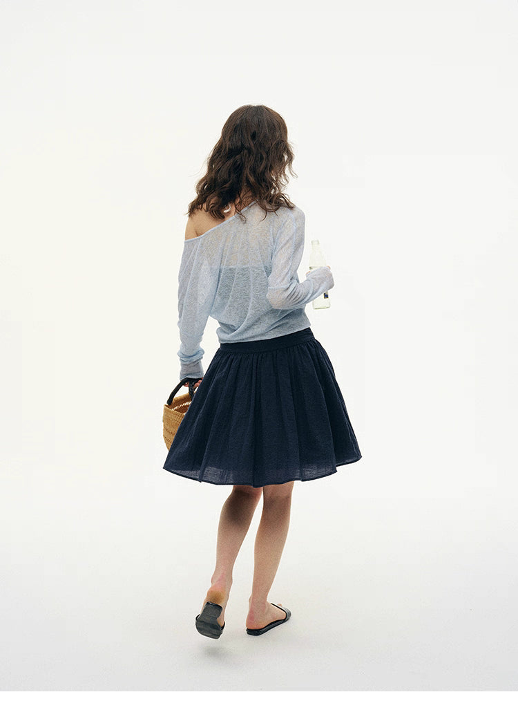 Back view of Sky Ice Blue layered knit worn off one shoulder with summer skirt