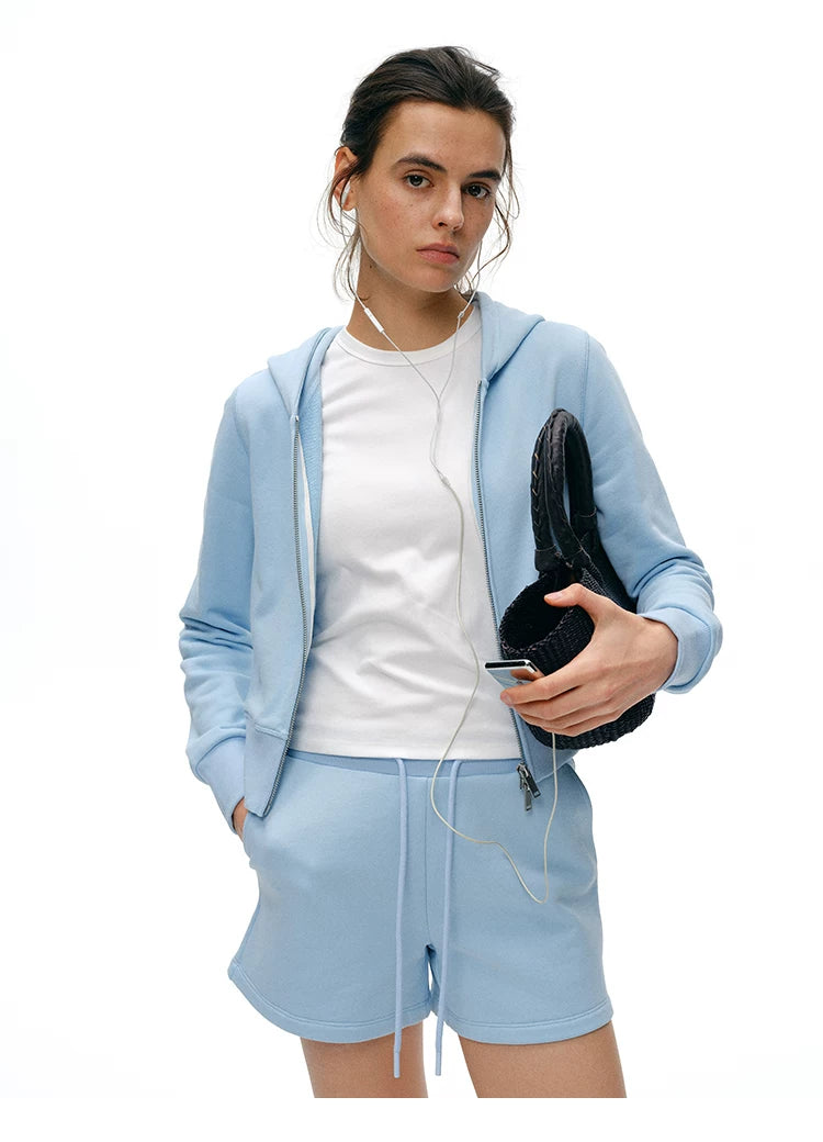 Waist-up front view of Light Blue cropped zip hoodie with two-way zipper