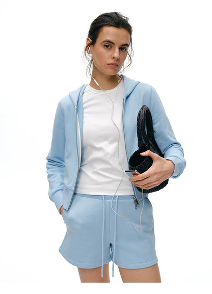 Waist-up front view of Light Blue cropped zip hoodie with two-way zipper