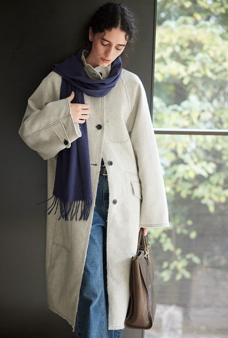 Light gray mid-length padded coat with a button-tab cuff, front view
