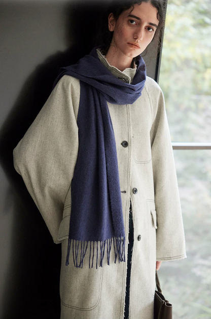 Light gray wool-blend coat showing the side flap pocket and raw-edge placket
