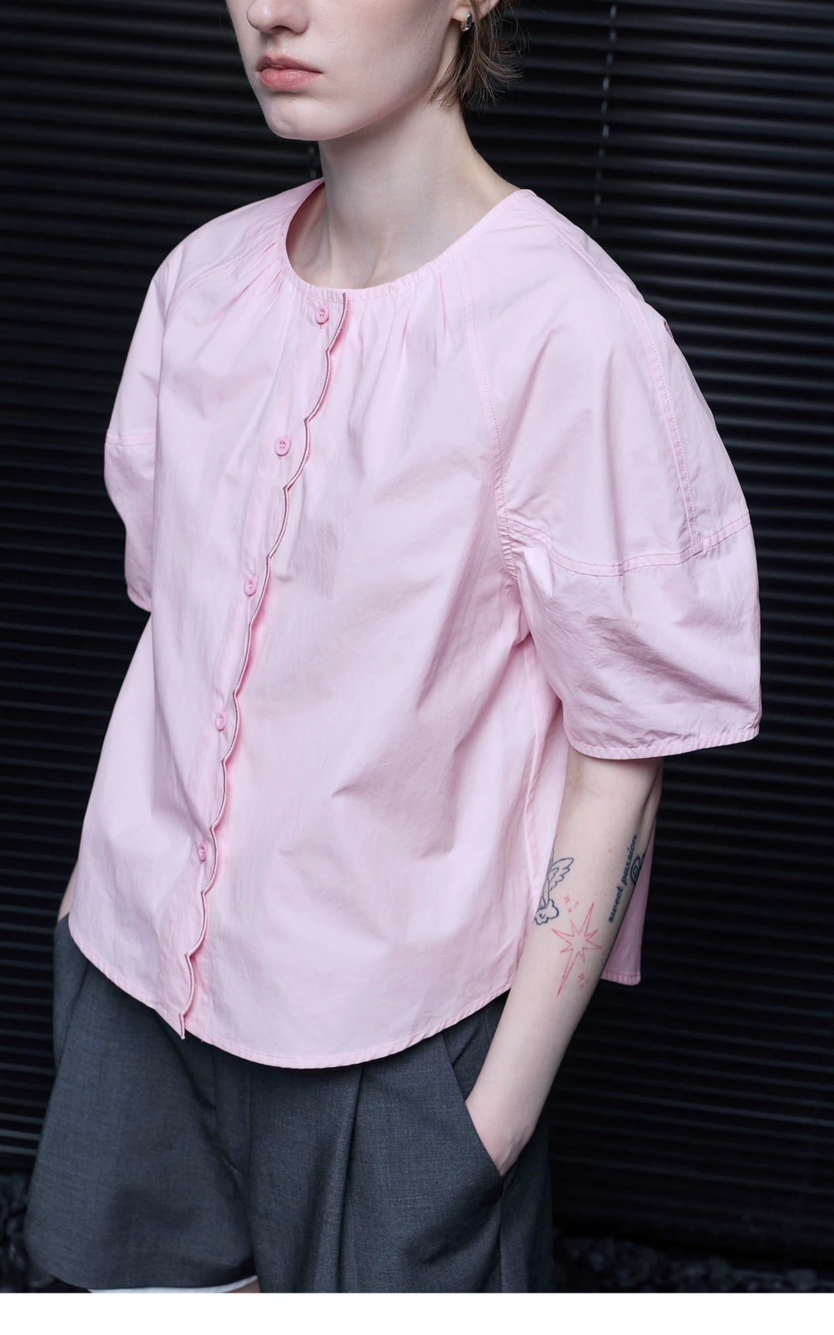 Close-up of Light Pink blouse showing scalloped placket, piping, and puff sleeve