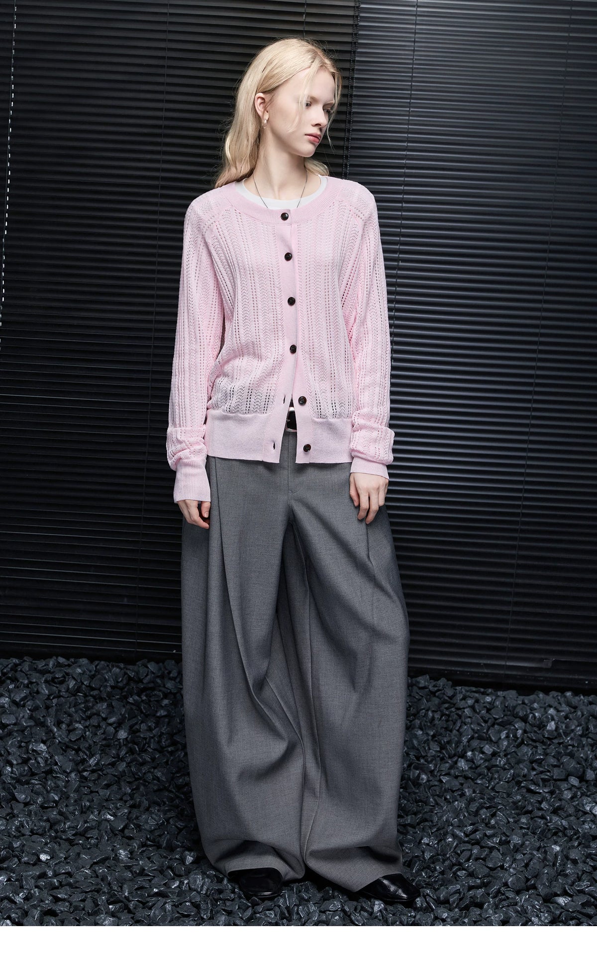 Full-length look of Light Pink pointelle cardigan worn with grey pleated wide-leg trousers
