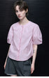Three-quarter front view of Light Pink blouse with scalloped placket and round buttons