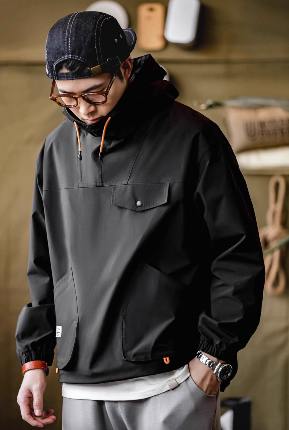 Man wearing Charcoal Black Lightweight Hooded Anorak Jacket front view highlighting chest flap pocket and relaxed fit