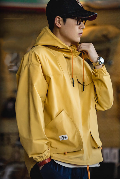 Side view of Ginger Yellow Lightweight Hooded Anorak Jacket worn by model showing sleeve shape, hood and relaxed silhouette