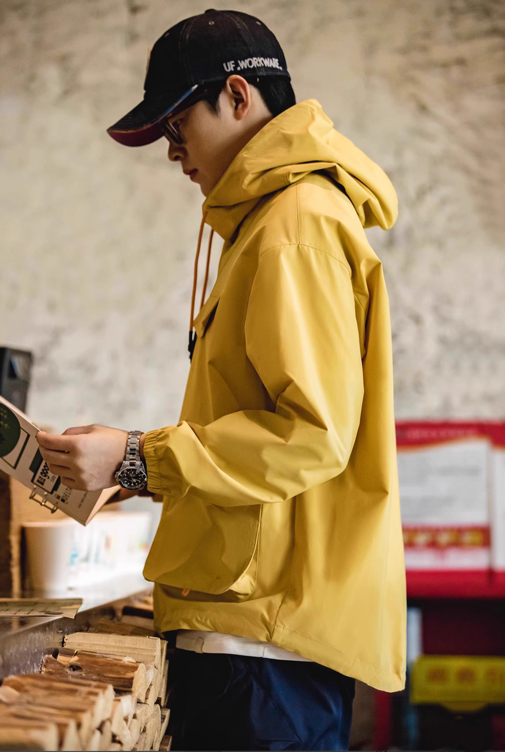 Side view of Ginger Yellow Lightweight Hooded Anorak Jacket worn by model in action highlighting lightweight material and everyday functionality
