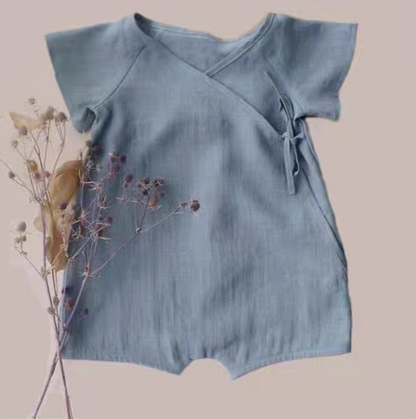 Blue cotton muslin baby romper with wrap tie closure front view