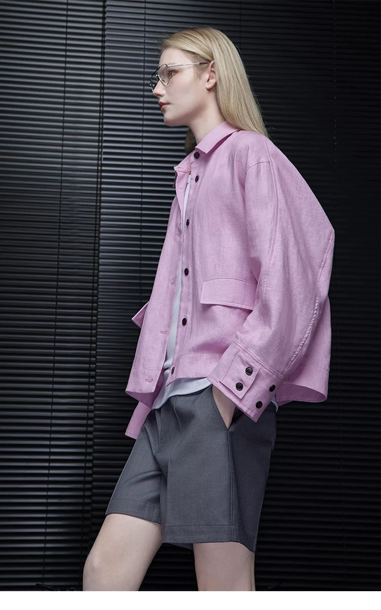 Side profile of a Lilac Pink cropped linen utility jacket with flap pocket and buttoned deep cuff