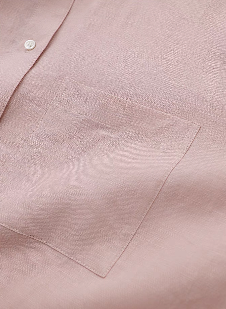 Pink linen collared shirt chest pocket close-up detail showing fabric texture and stitching