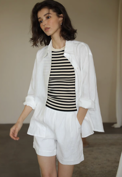 White linen collared shirt and high waisted shorts set front walking view styled with striped top