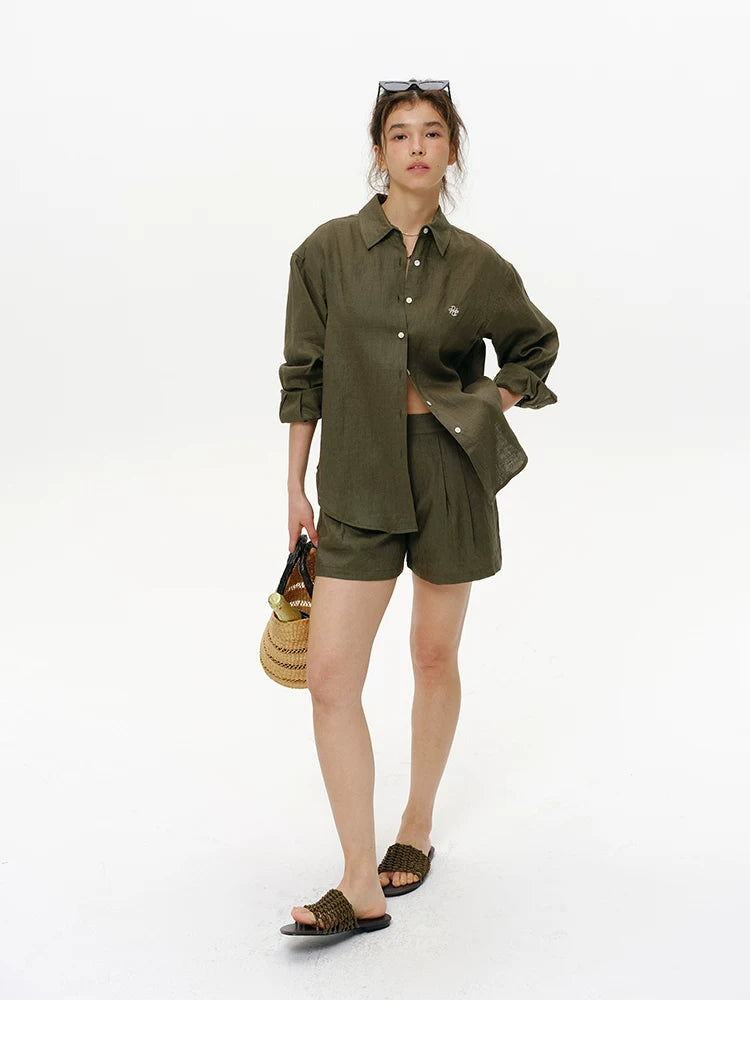 Olive green embroidered linen shirt styled with shorts and sandals, front view