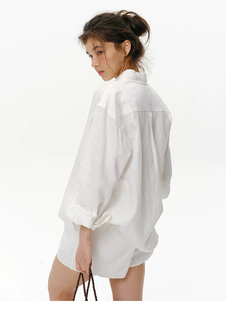 Back view of white linen shirt showing relaxed drop-shoulder fit