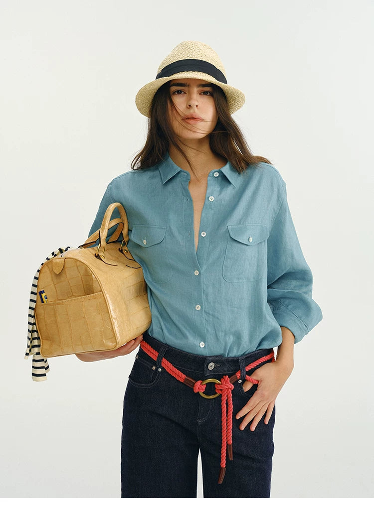 Close-up front view of blue linen utility shirt with tote bag