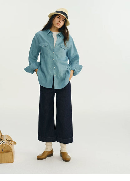 Full outfit view of blue linen utility shirt with wide-leg denim trousers