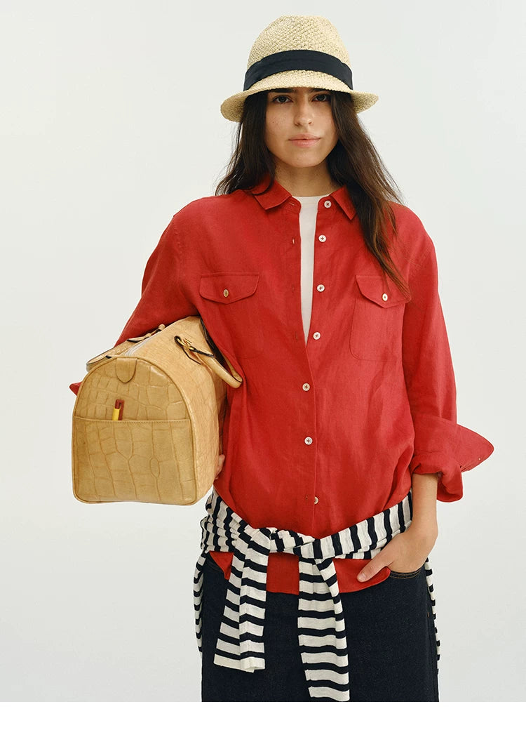 Front view of red linen utility shirt with chest pocket detail and tote bag