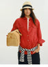 Front view of red linen utility shirt with chest pocket detail and tote bag