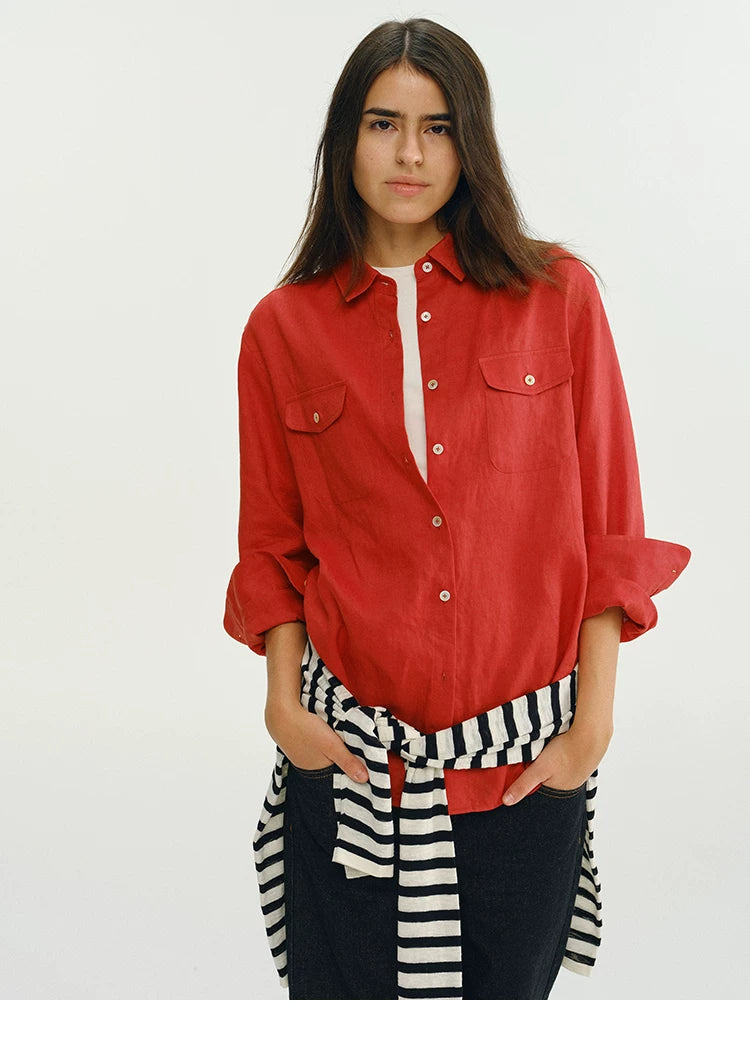 Woman wearing red linen utility shirt with striped tie belt, front view