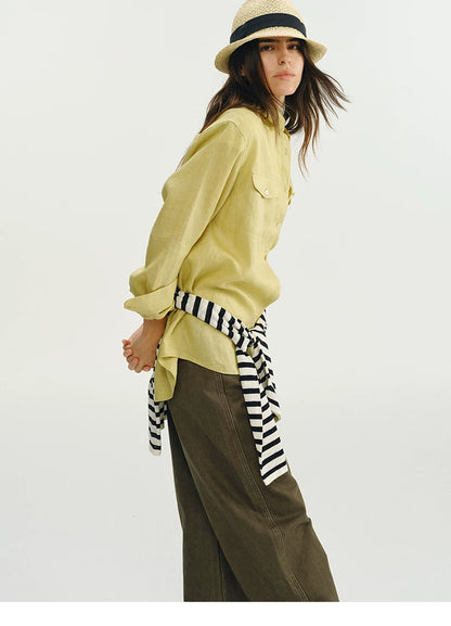 Side view of yellow linen utility shirt styled with striped tie belt