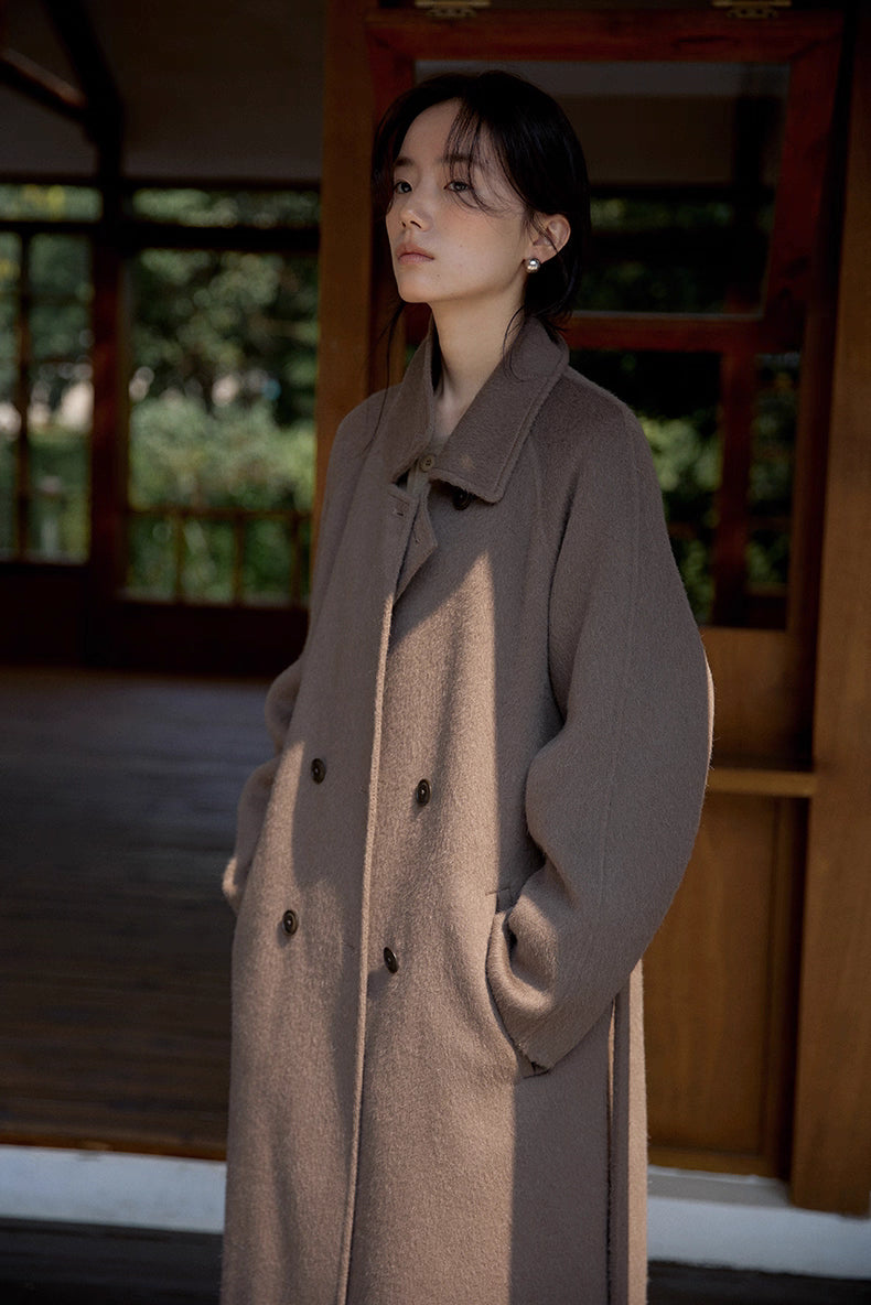Close-up of upper body showing buttons, collar and soft texture of coffee brown wool coat