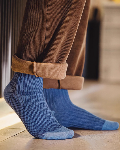 Lucky Chunky Knit Socks in navy blue worn with cuffed brown pants showing side profile and breathable chunky knit texture