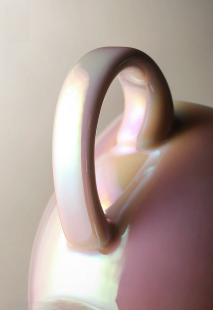 Close-up detail of luminous iridescent pink ceramic coffee cup handle showing glossy reflective glaze and smooth craftsmanship