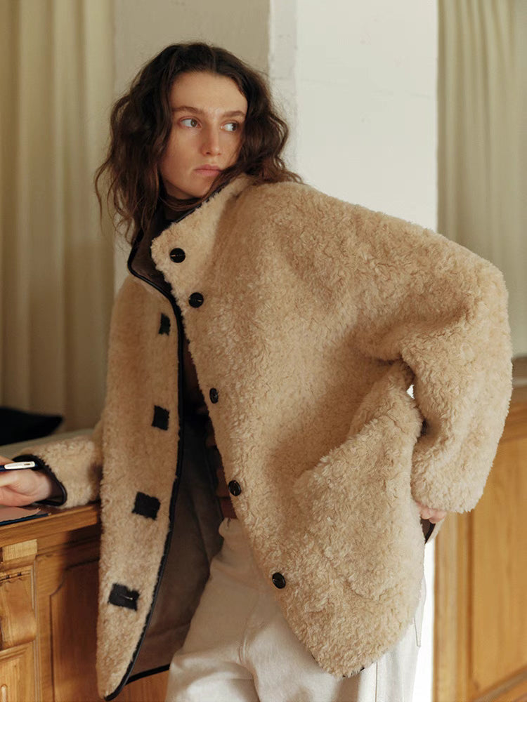 Model wearing Luxe Contrast Shearling Coat in Apricot Beige short style featuring plush wool texture, stand collar, contrast trim, and toggle-button front closure
