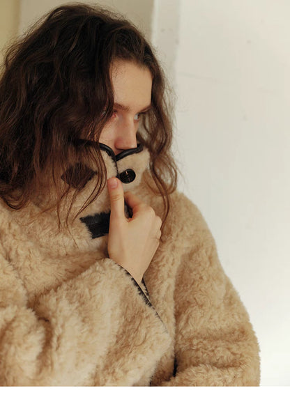 Close-up of Luxe Contrast Shearling Coat in Apricot Beige showing stand collar, toggle-button detail, and plush shearling texture