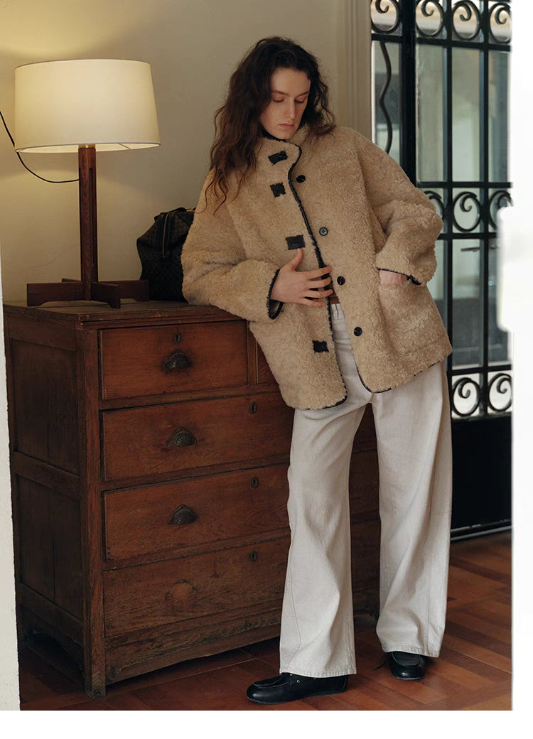 Model styling Luxe Contrast Shearling Coat in Apricot Beige short style with relaxed fit, front pockets, and casual indoor outfit