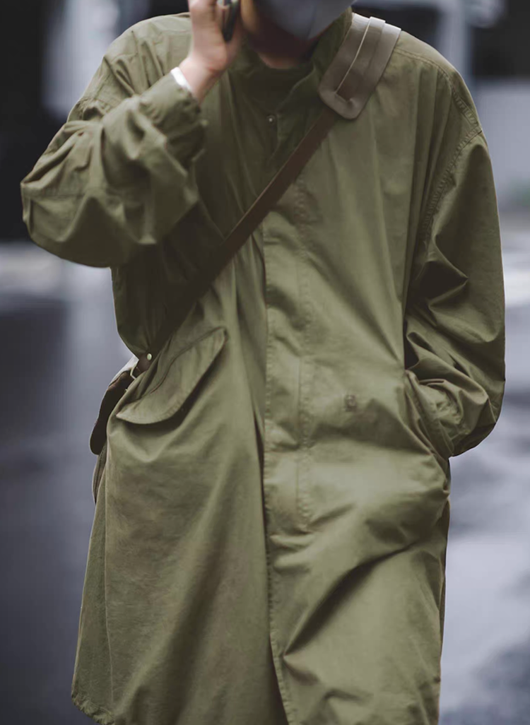 Model wearing M-65 fishtail parka walking outdoors