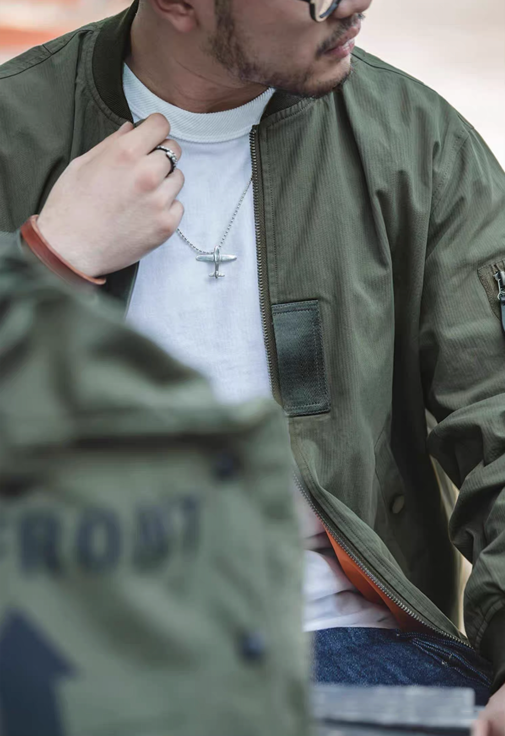 Close-up of MA-1 bomber jacket in green with chest details
