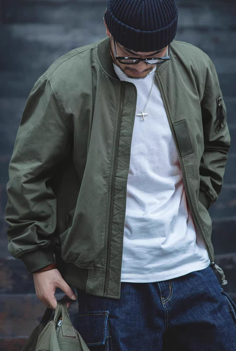 Model wearing green MA-1 bomber jacket streetwear style