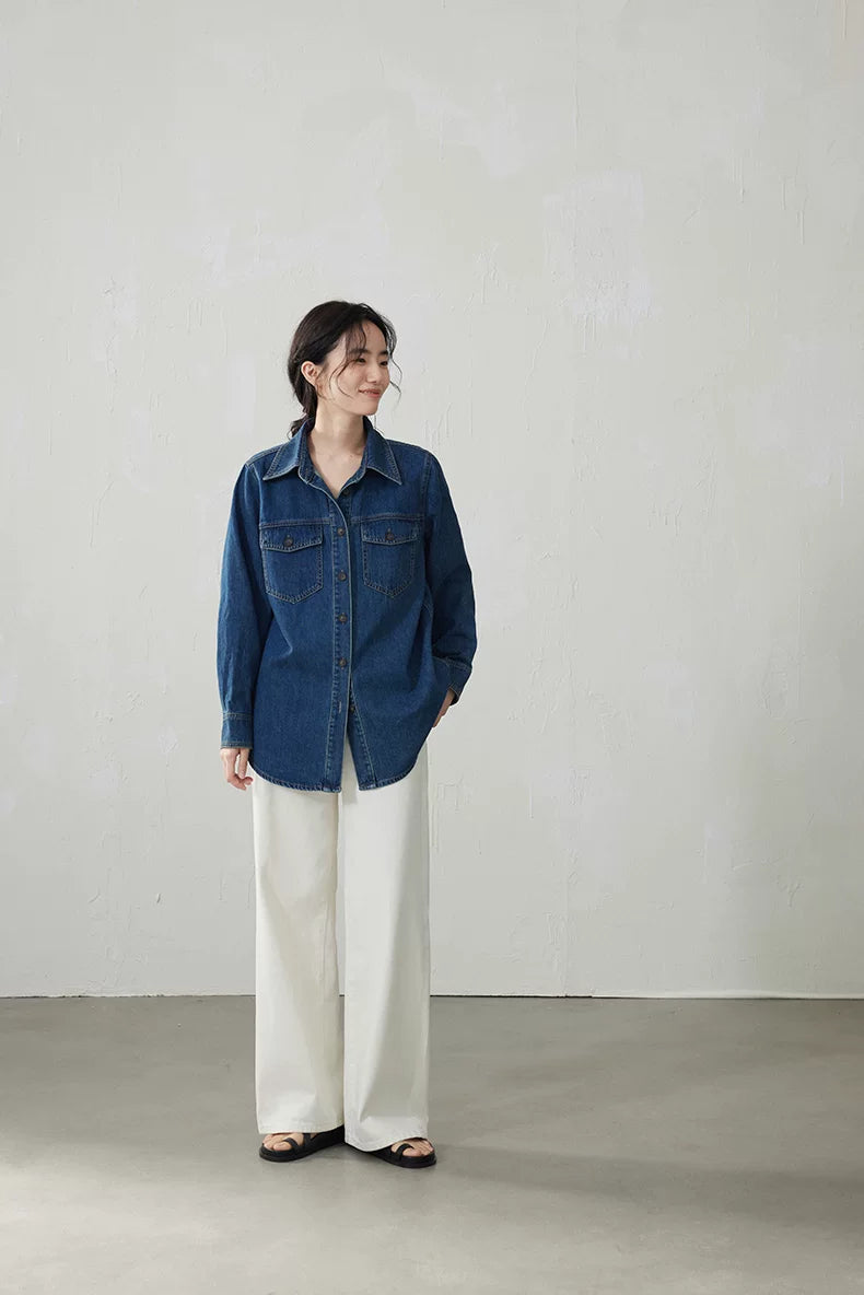 Full-length front view of a medium blue relaxed denim overshirt worn untucked