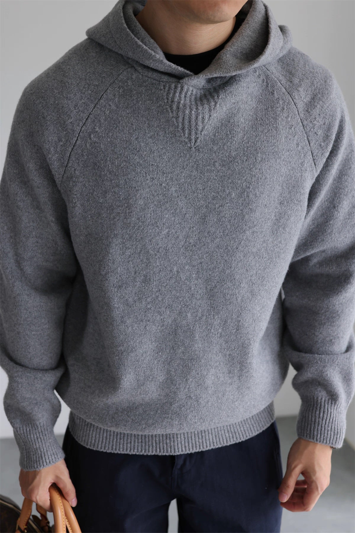 Minimalist gray knit hoodie front view, soft wool-blend brushed sweater