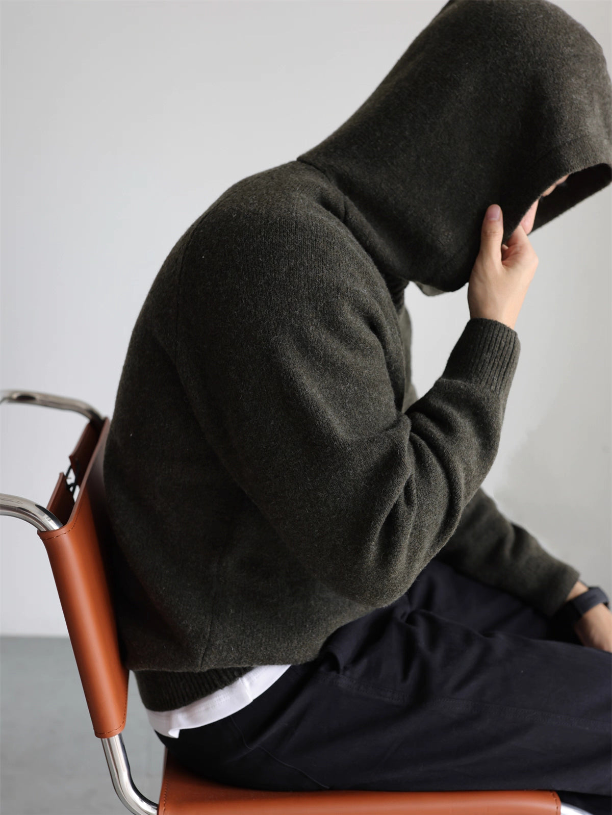 Side profile with hood up, olive wool-blend knit hoodie
