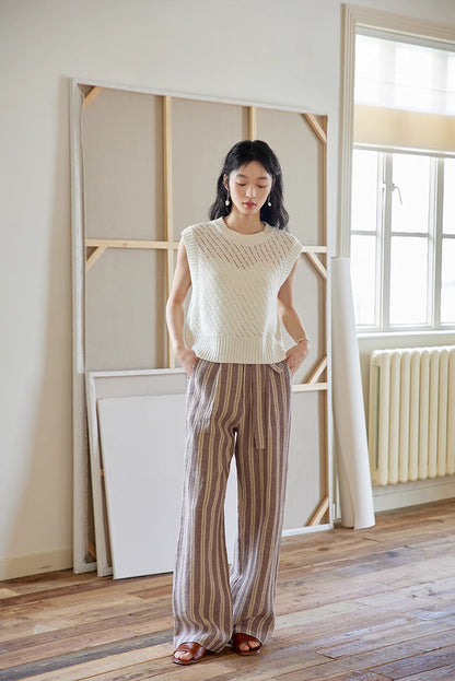 Full-body view of Camellia White knit top paired with striped wide-leg pants, emphasizing airy openwork texture and effortless summer styling