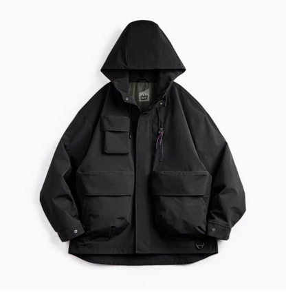 Metro Flex Waterproof Jacket in Black front view showing hooded design, front zip closure and multiple utility flap pockets