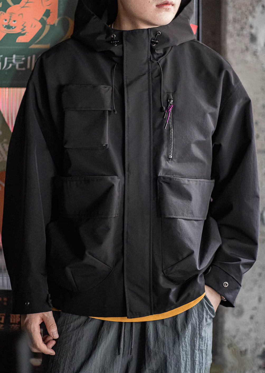 Front view of Black Metro Flex Waterproof Jacket worn by model highlighting chest zip pocket, large flap pockets and relaxed fit