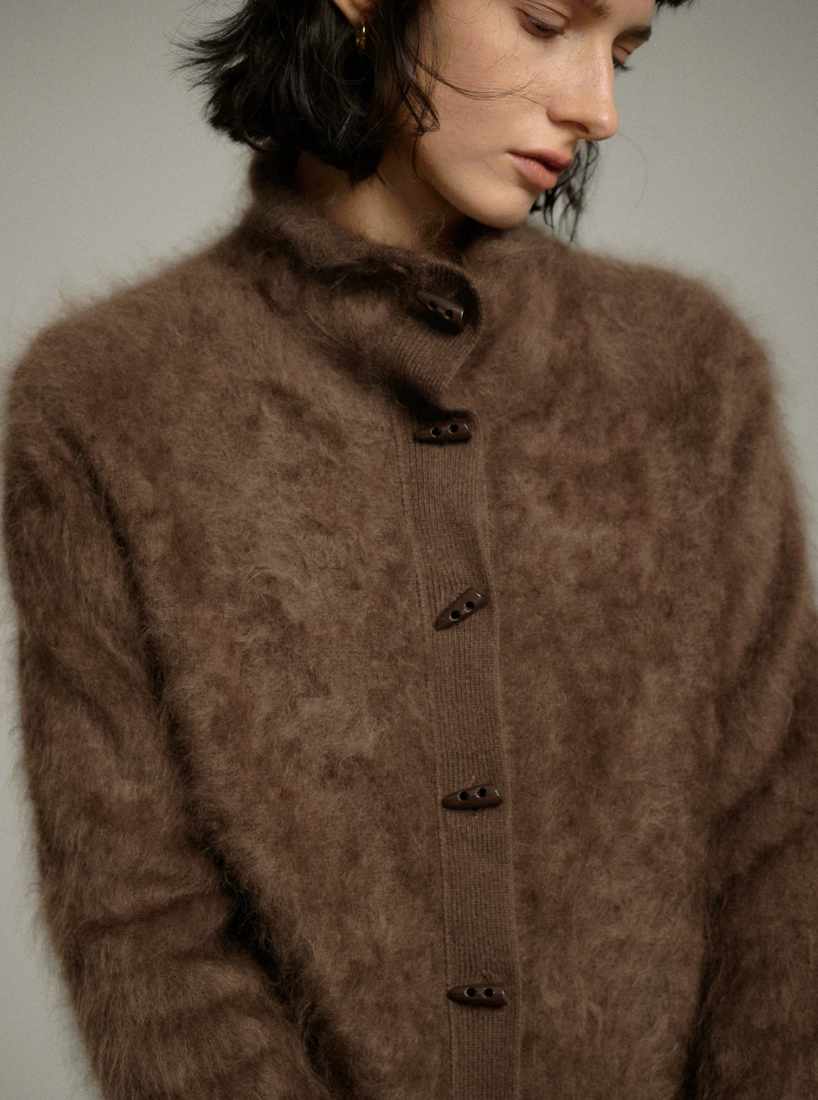 Close-up of a Mocha halo-soft cashmere cardigan’s mock neck and toggle-shaped buttons