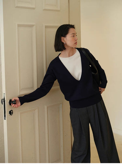 Navy Blue Modern V-Neck Relaxed Sweater worn while reaching door handle showing casual styling and loose fit design