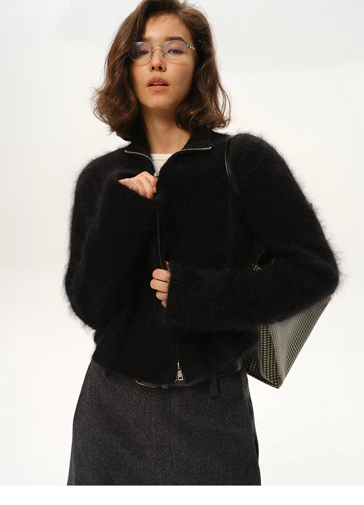 Woman wearing black fuzzy mohair zip cardigan with high neck