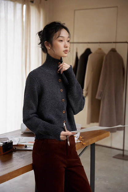 Dark gray mock neck cardigan three quarter view showing textured wool knit and relaxed silhouette