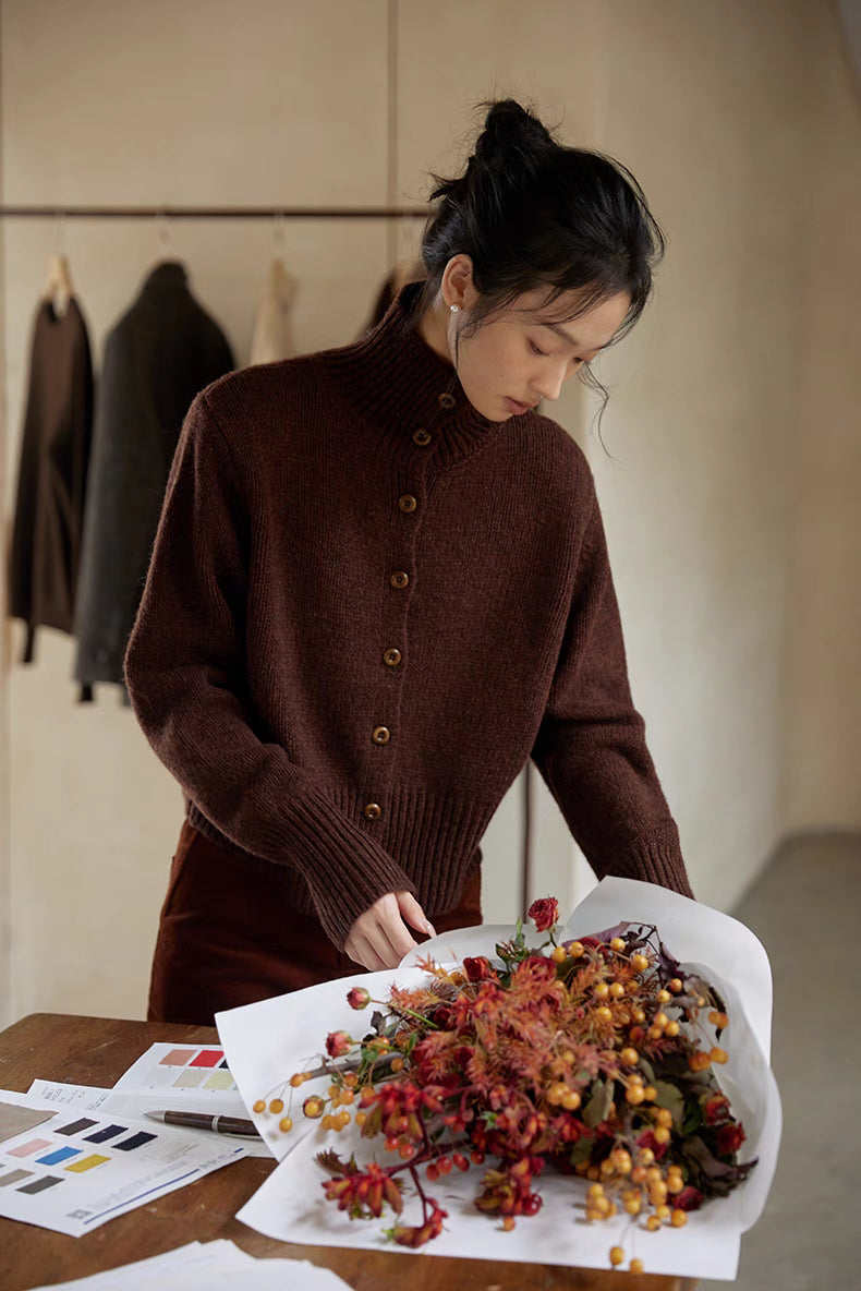 Red chestnut brown wool cardigan close-up showing soft texture, ribbed cuffs and natural buttons