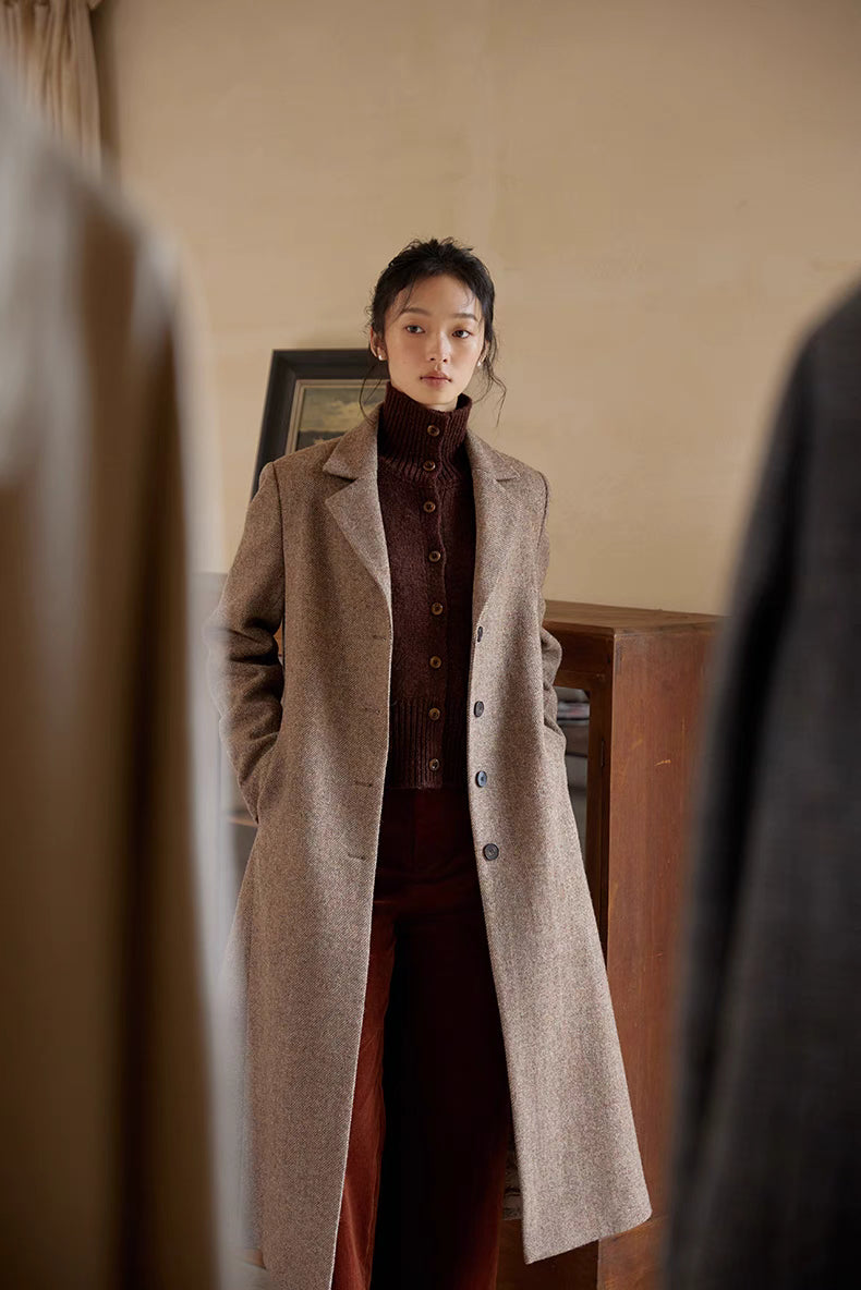 Red chestnut cardigan layered under coat showcasing mock neck design and warm textured knit