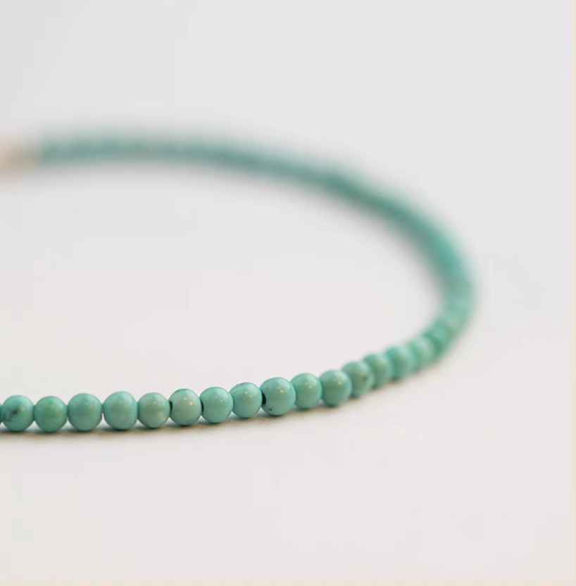 Close-up of natural turquoise bracelet with 3.5mm beads highlighting smooth surface and color variation