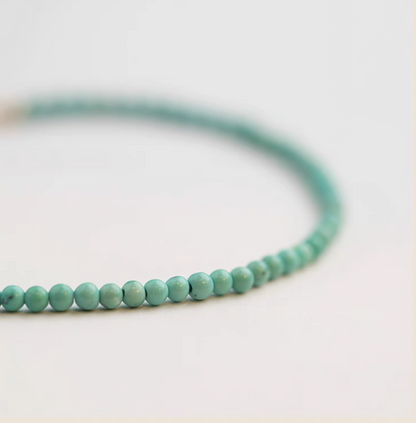 Close-up of natural turquoise bracelet with 3.5mm beads highlighting smooth surface and color variation