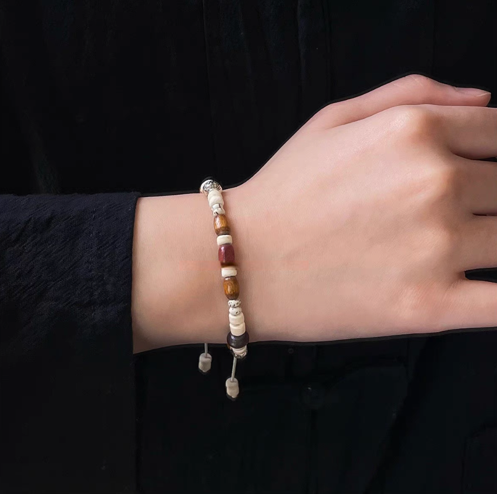 natural wood bead adjustable bracelet worn on wrist showing multicolor wooden beads and adjustable cord design